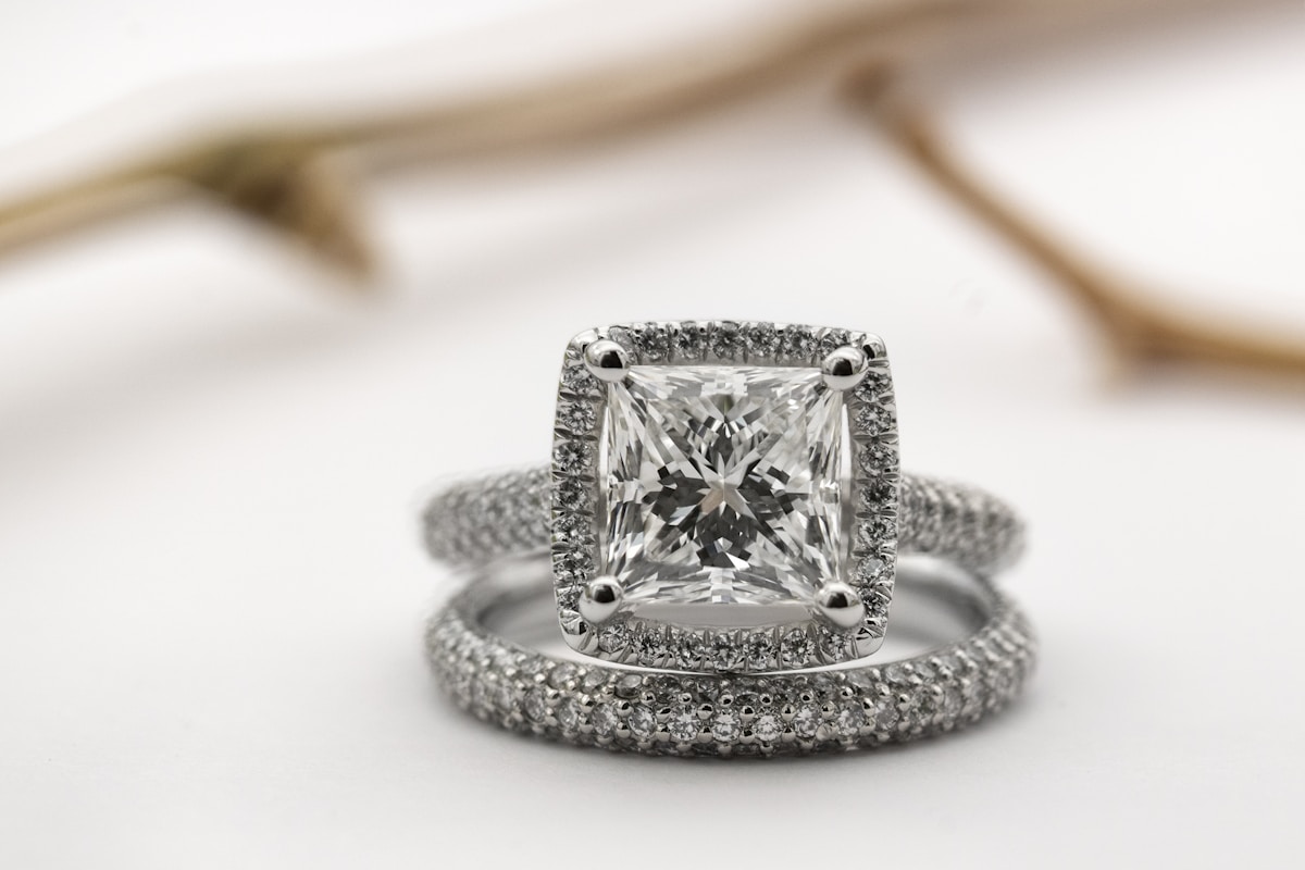 A princess cut halo engagement ring with a matching pavé wedding band
